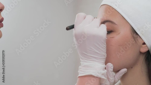 Side view of girl with perforation lines on face in clinic