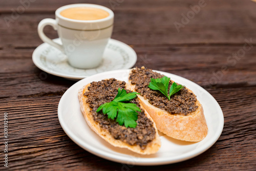 Fresh tasty bruschetta with truffle sauce, parsley, tomates and cup of coffee