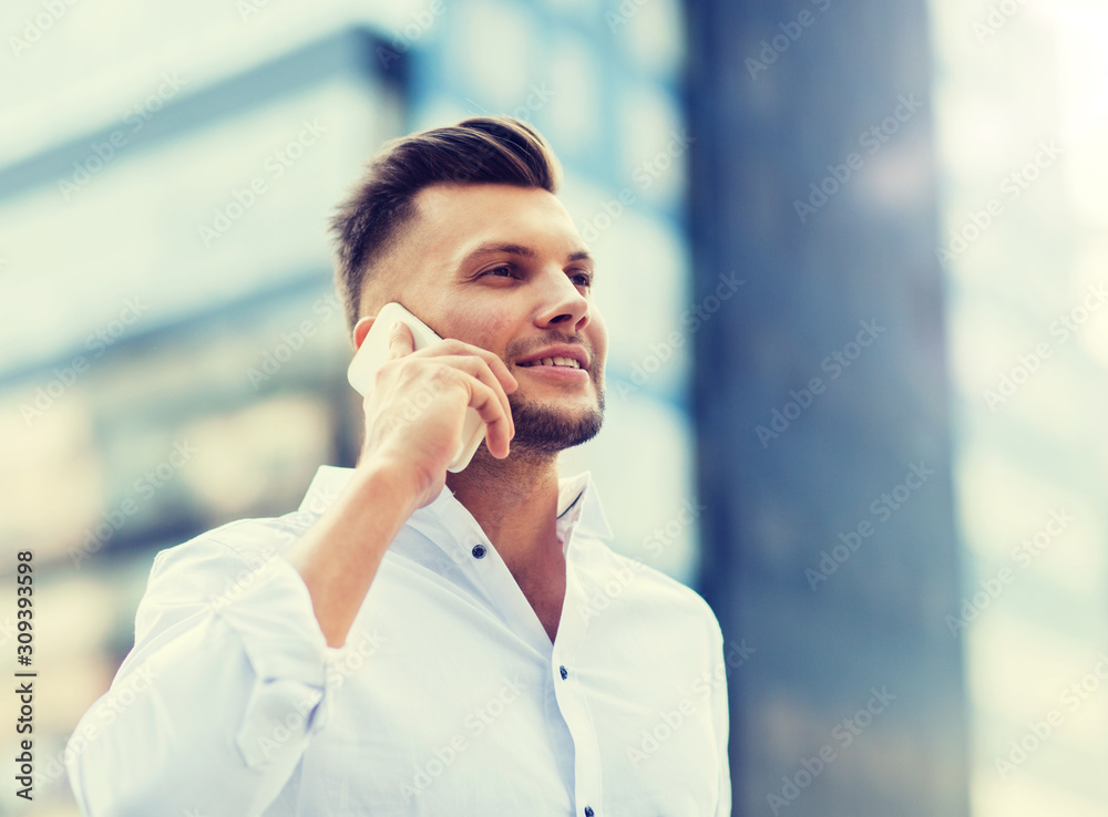 technology, communication and people concept - happy man with smartphone calling on city street technology, communication and people concept - happy man with smartphone calling on city street