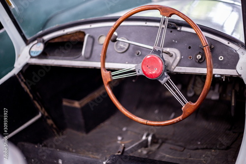 steering wheel inside a vintage car .