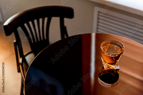 Glass of fresh apple juice on a wooden table close