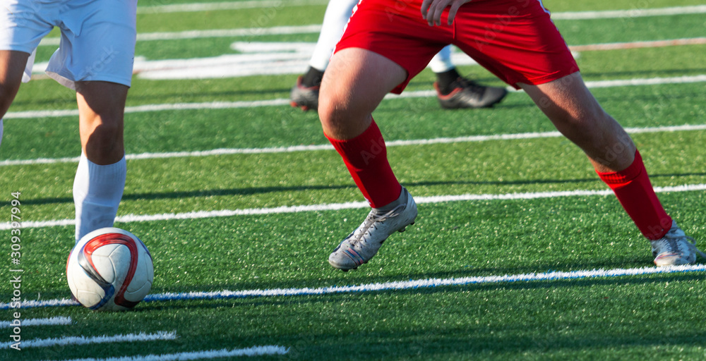 Legs of soccer players fighting for the ball Legs of soccer players fighting for the ball