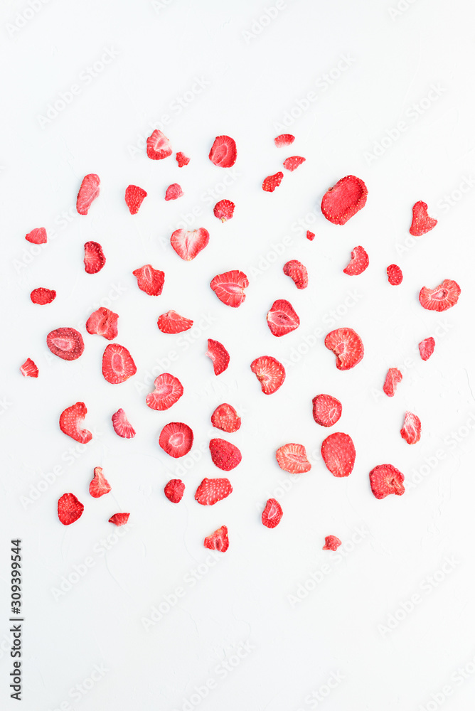 Sliced ​​sublimated strawberries on a white background.