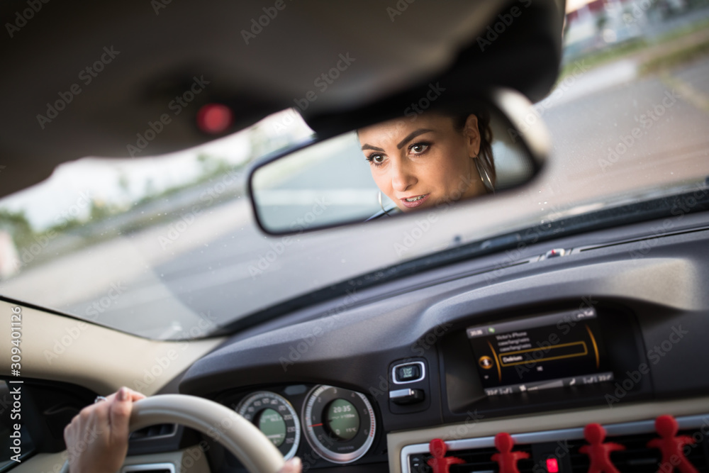 Pretty, young woman driving a car -Invitation to travel. Car rental or vacation. Pretty, young woman driving a car -Invitation to travel. Car rental or vacation.