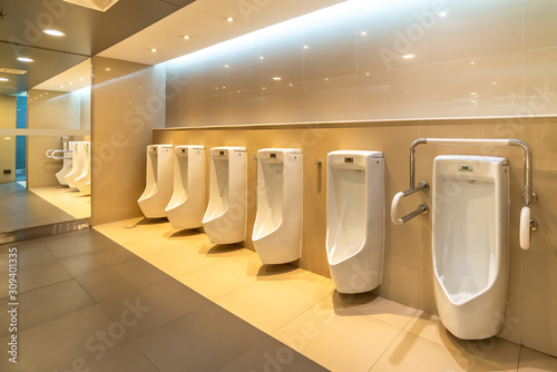 White urinals in men public restroom