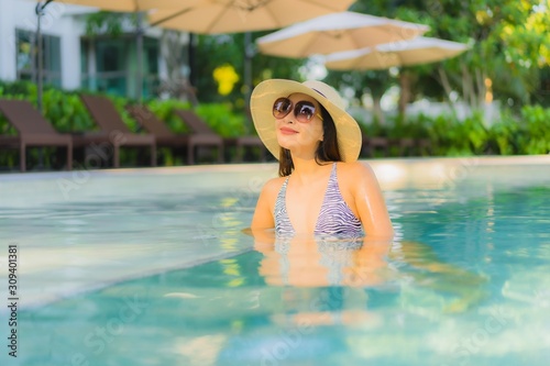 Beautiful young asian women happy smile relax around outdoor swimming pool in hotel resort for travel in holiday vacation