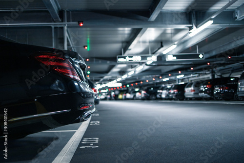 Photographie Underground garage or modern car parking with lots of vehicles