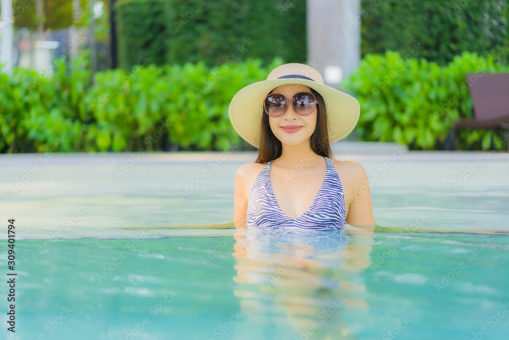 Beautiful young asian women happy smile relax around outdoor swimming pool in hotel resort for travel in holiday vacation