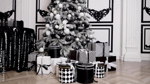 Merry Christmas. Christmas tree decorated with lights, Christmas interior background. Christmas tree with white and black balls.