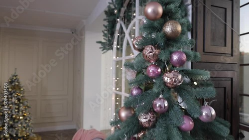 Merry Christmas. Christmas tree decorated with lights, Christmas interior background. Christmas tree with white and black balls.
