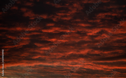 Dark Red Orange and Yellow Clouds Hang Over the Landscape © Nikolai