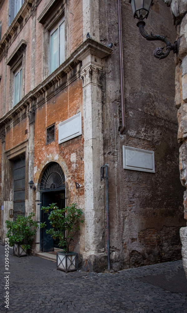 Corner of an old house in a cobbled street in Rome