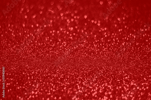 Abstract red background with hart shape bokeh. Sparkling and shine monochrome backdrop with little hearts.