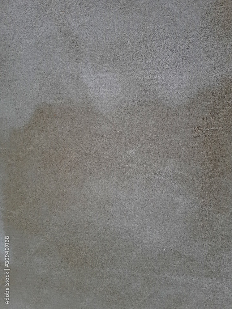 Naklejka premium close-up of a decorative wall, with bokeh effect and characteristic rough porous texture, abstract dark and light stains