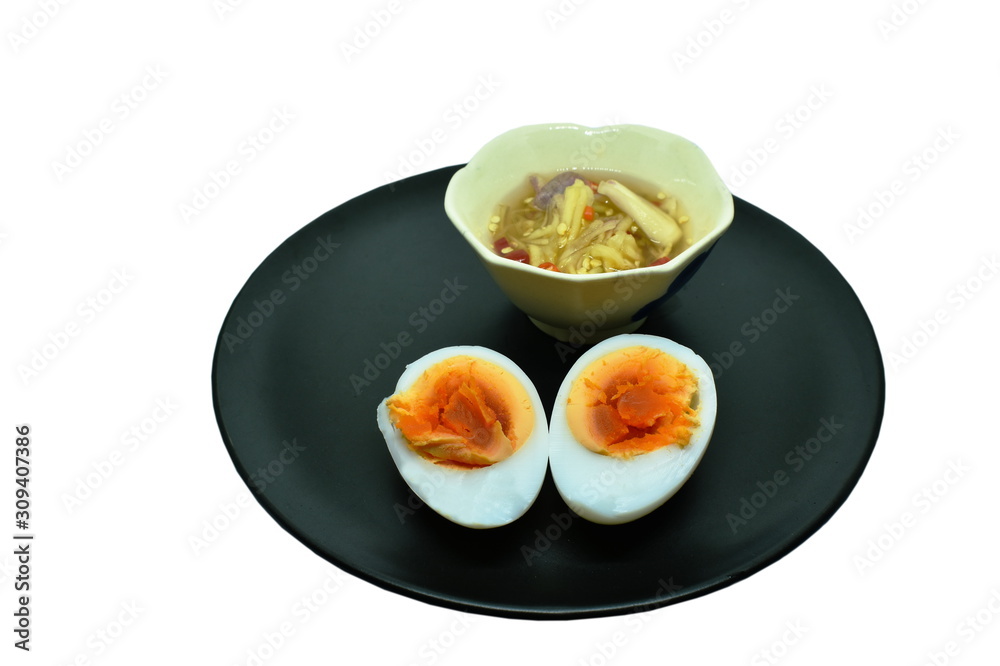 boiled egg and yolk half cut on plate dipping with spicy sauce boiled egg and yolk half cut on plate dipping with spicy sauce