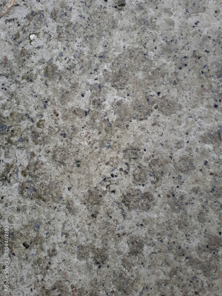 close-up of a decorative wall made of concrete, with a characteristic rough porous texture, abstract dark and light stains close-up of a decorative wall made of concrete, with a characteristic rough porous texture, abstract dark and light stains