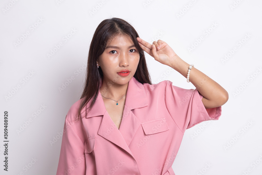 Beautiful young Asian woman holding fingers in gun gesture. Beautiful young Asian woman holding fingers in gun gesture.