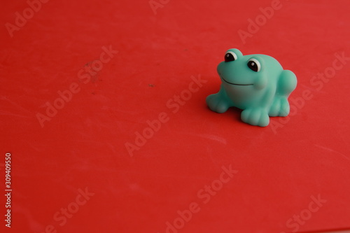 child toy for green frog bathtub © robcartorres