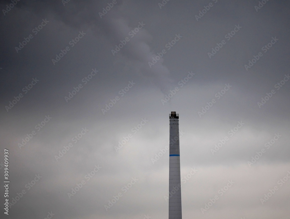 Fumes from incinerator chimney on a misty murkey day