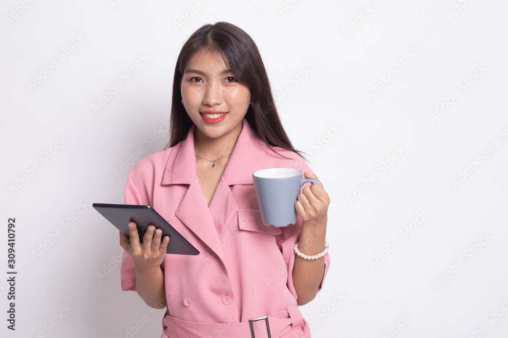 Young Asian woman with a computer tablet and coffee. Young Asian woman with a computer tablet and coffee.