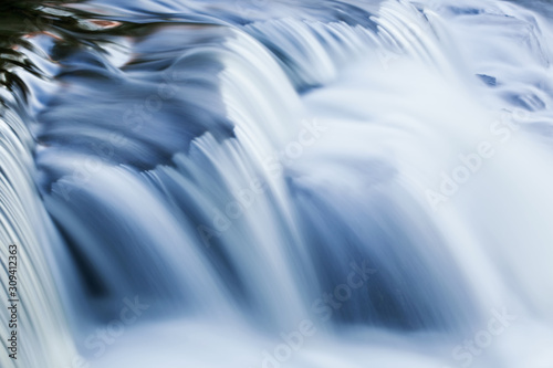 Bond Falls cascade illuminated by reflected color from blue sky overhead and captured with motion blur, Ottawa National Forest, Michigan's Upper Peninsula, USA