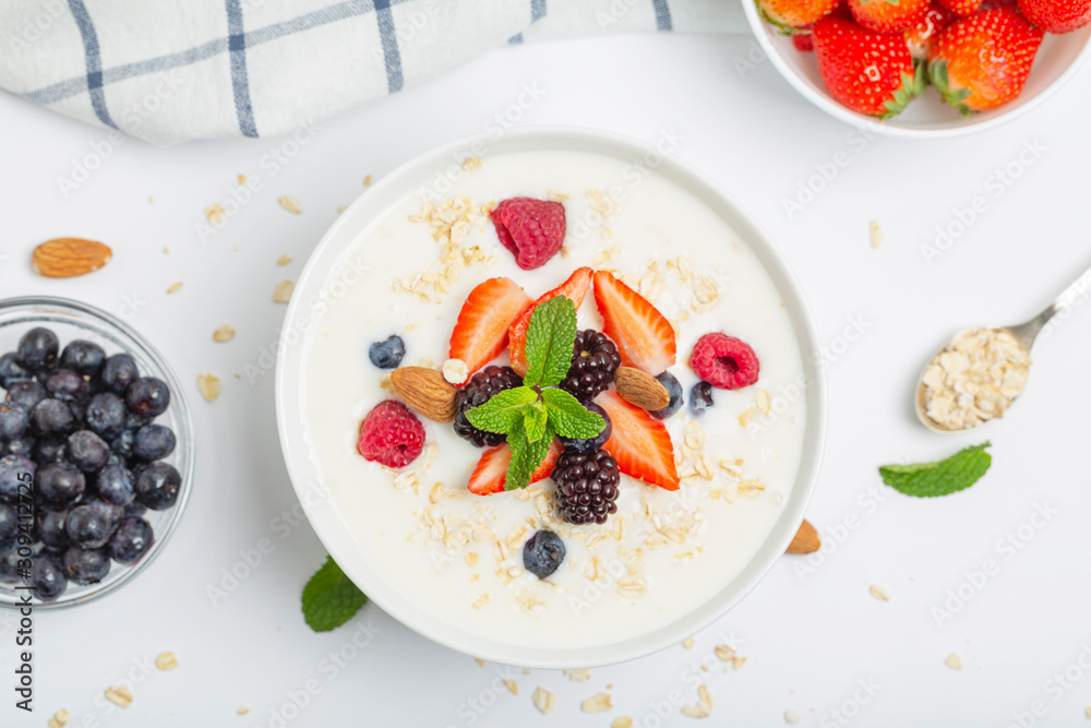 Yogurt with granola, fresh strawberries, raspberry, blueberries, blackberries, almonds and mint. Healthy snack. Breakfast food. Yogurt with granola, fresh strawberries, raspberry, blueberries, blackberries, almonds and mint. Healthy snack. Breakfast food.