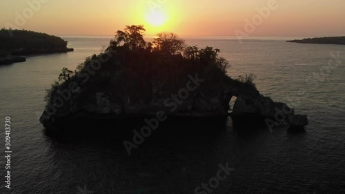 Rock in Crystal Bay at sunset , Nusa Penida island, Indonesia photo