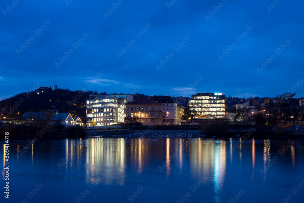  Night city landscape and panorama in the bright evening lights of the Czech capital Prague overlooking the Vltava River.