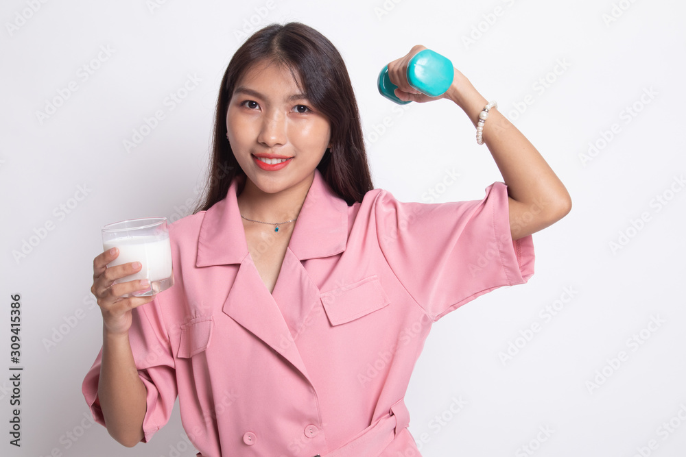 Healthy Asian woman drinking a glass of milk and dumbbell. Healthy Asian woman drinking a glass of milk and dumbbell.