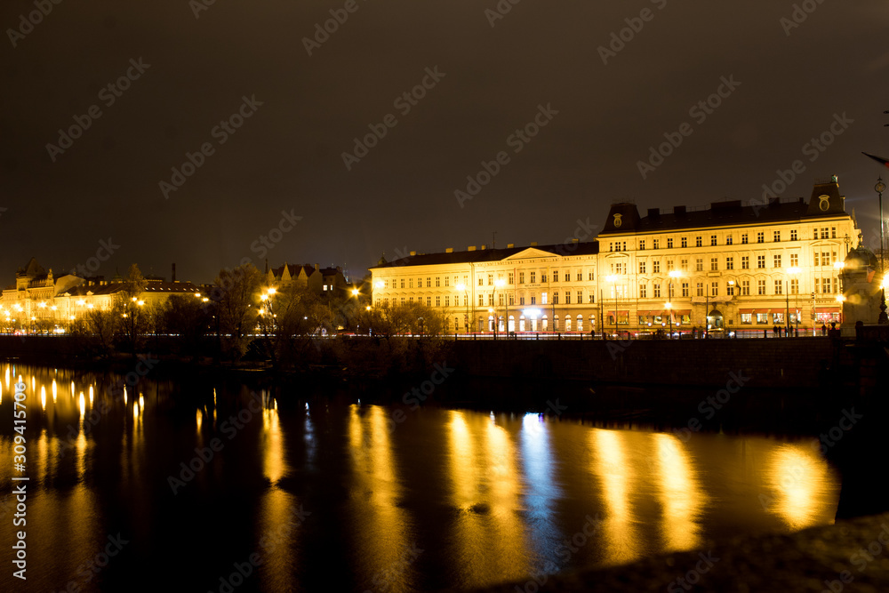  Night city landscape and panorama in the bright evening lights of the Czech capital Prague overlooking the Vltava River.