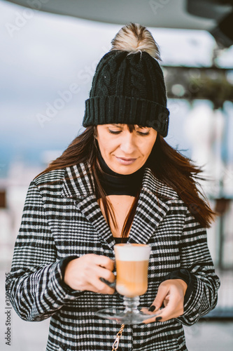 attractive woman with cup of coffee in hands