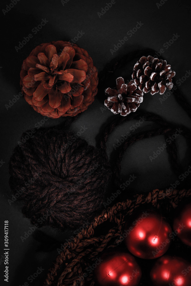 Naklejka premium Pines and ornaments in a wooden knitted basket.