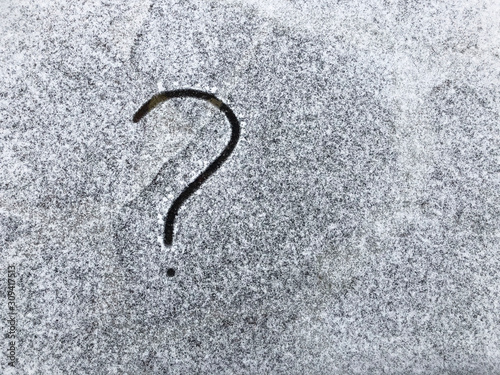 Question mark drawn on white snowy surface. Copy space. Confusion © Kate