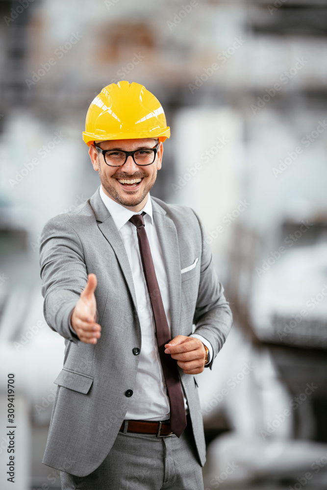 Architect with helmet. Businessman in factory handshaking. Architect with helmet. Businessman in factory handshaking.