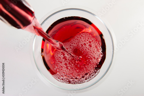 Glass of red wine with shadow.Top view. Abstract red wine bubbles. photo