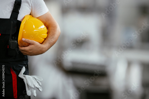 Close up of worker holding helmet photo