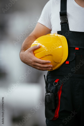 Close up of worker holding helmet
