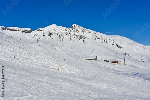 skiers on mountainside in switzerland 