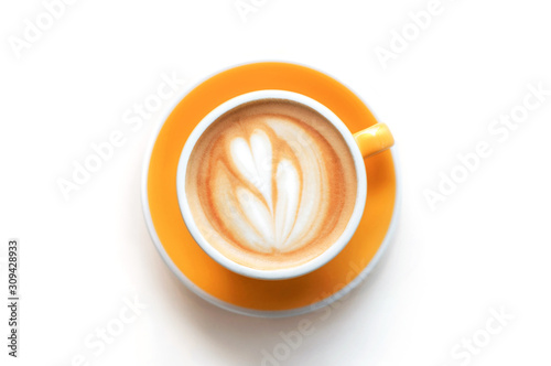 Cappuccino with frothy foam  yellow coffee cup top view closeup isolated on white background. Flat lay style.