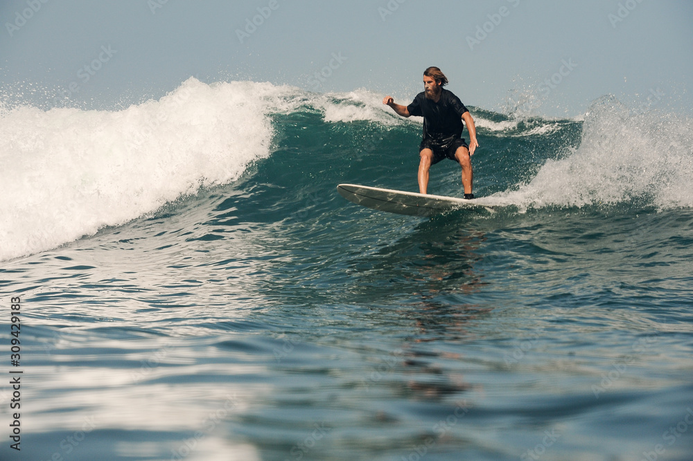 Surfer with beard on the board in ocean Surfer with beard on the board in ocean