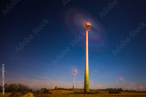 Wind turbine spinning fast at night sky in Lithuania, Europe