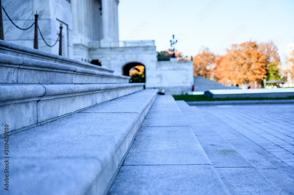 Floor level view down the United States of America Capitol steps with fall colored trees in the distance Floor level view down the United States of America Capitol steps with fall colored trees in the distance