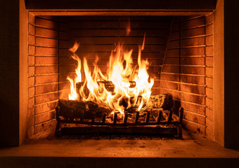 Burning fireplace, real wood logs, cozy warm home at xmas time
