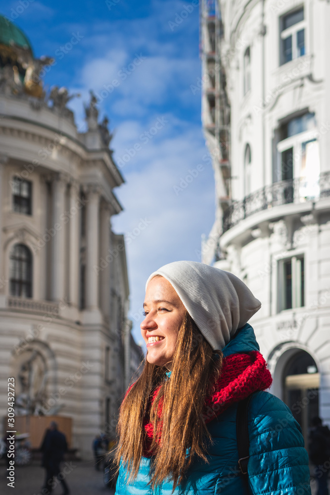 Happy smiling woman at city street in Vienna, Austria near Hofburg