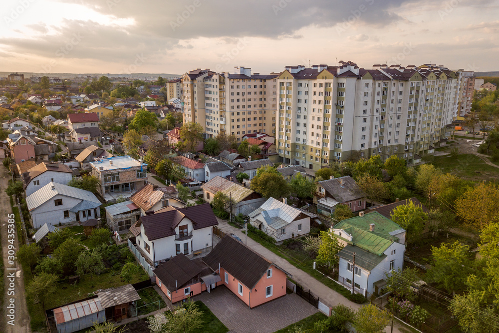 Aerial view of multistory apartment buildings in green residential area.