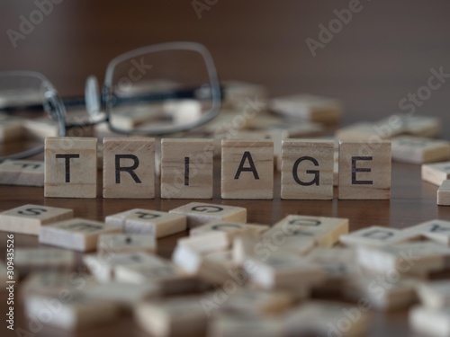 triage the word or concept represented by wooden letter tiles photo