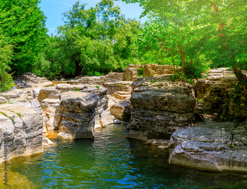 Okatse first canyon and small Kinchkha waterfall in the canyon of the river Okatse. Rest in Georgia. Rocky ledges of the mountain with green trees