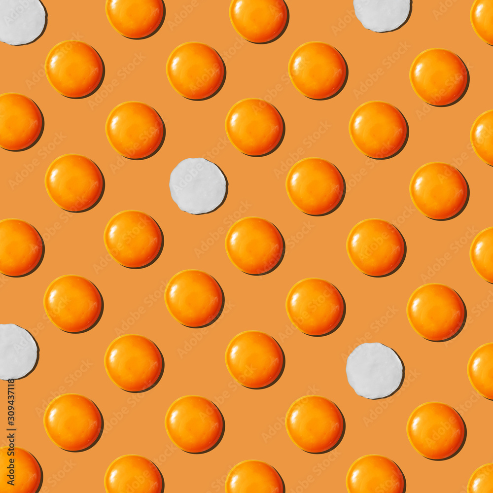 Eggs yolks and eggwhites pattern on a yellow background. Flat lay. Eggs yolks and eggwhites pattern on a yellow background. Flat lay.