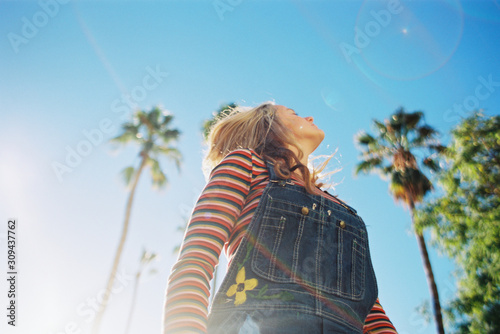 Teen girl with rainbow stripes in bright colors on film