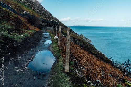 Muddy Trekking Pathway on the Coastline Facing the Ocean . Landscape Stock Picture of Ireland photo